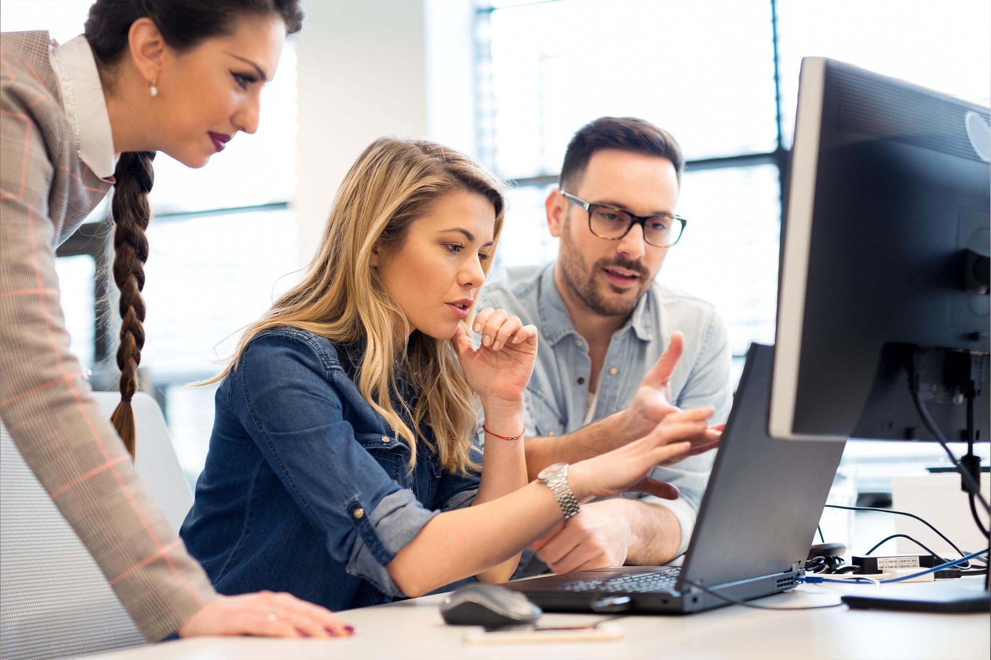 Employees reviewing a computer screen