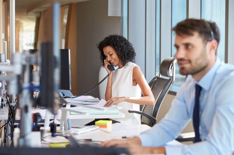 Happy business woman talking on phone